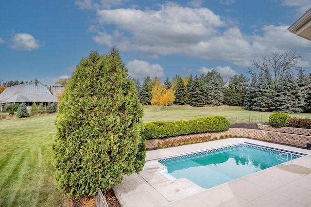 pool featuring a yard and fence