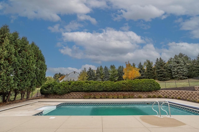 view of swimming pool with fence and a fenced in pool