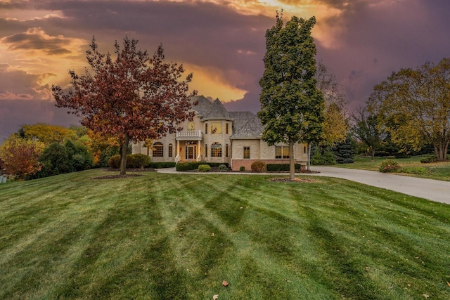 view of front of home with a front yard and stone siding