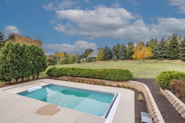 view of swimming pool with fence, a fenced in pool, a patio, and a yard