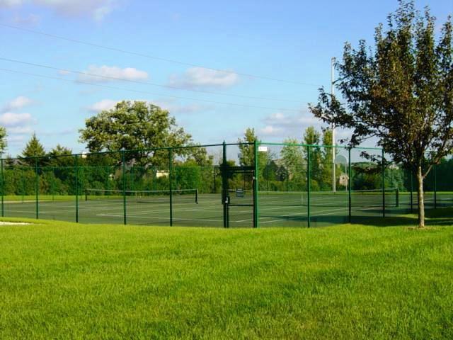 view of sport court featuring a lawn and fence