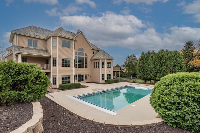 view of pool with a patio area, a fenced in pool, and fence