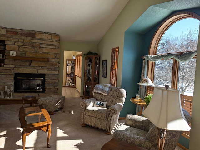 carpeted living room featuring lofted ceiling and a fireplace