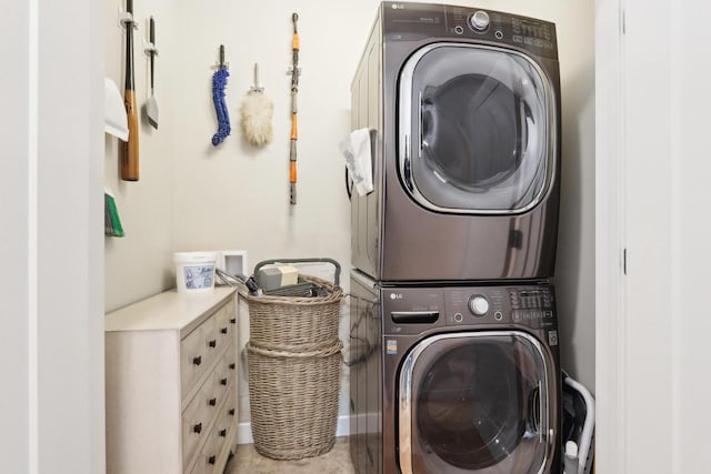 clothes washing area with stacked washer / dryer