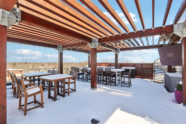 snow covered patio featuring a pergola