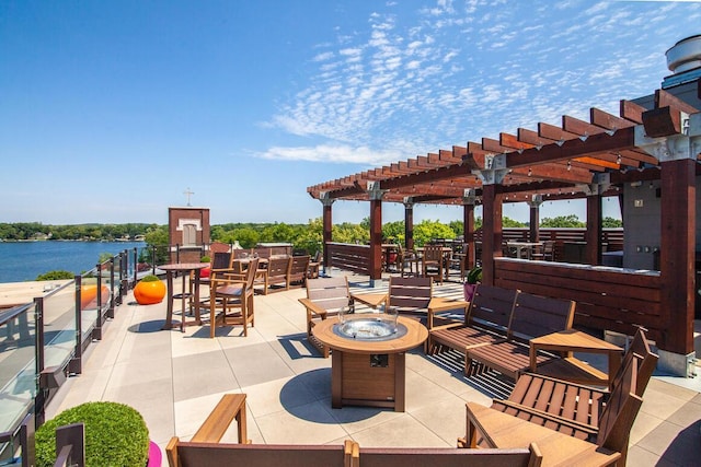 view of patio with a water view and an outdoor fire pit