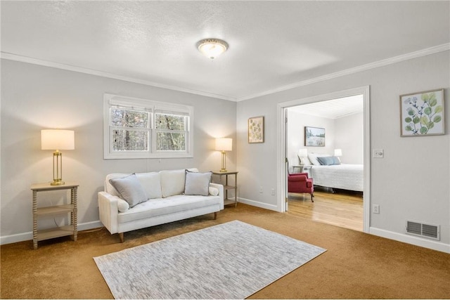 carpeted living area featuring a textured ceiling, ornamental molding, visible vents, and baseboards