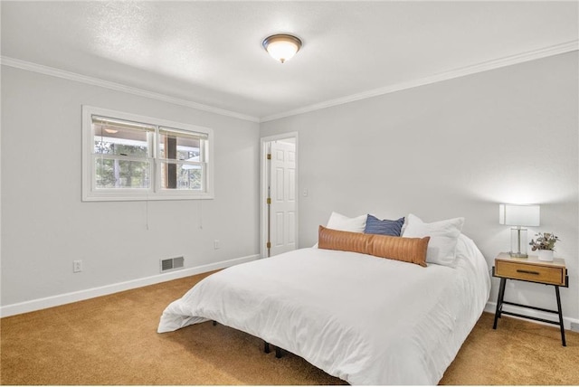 bedroom with baseboards, crown molding, visible vents, and light colored carpet