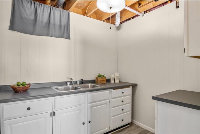 bathroom with a sink and wood finished floors