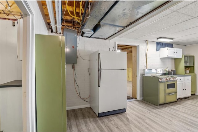 interior space featuring light wood-style flooring, freestanding refrigerator, and electric panel