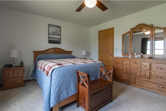 bedroom featuring a ceiling fan and light colored carpet