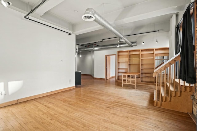 interior space featuring baseboards, visible vents, and wood finished floors