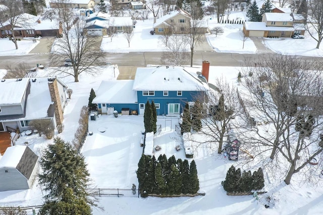 snowy aerial view with a residential view