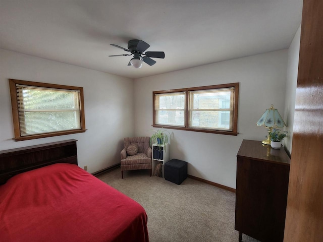 bedroom with baseboards, light colored carpet, and a ceiling fan