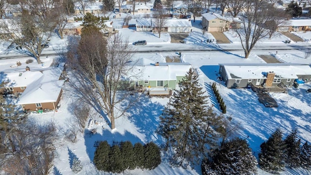 snowy aerial view with a residential view