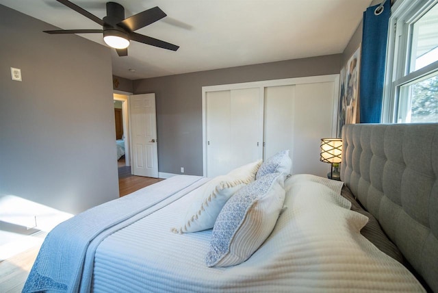 bedroom featuring ceiling fan, a closet, and wood finished floors