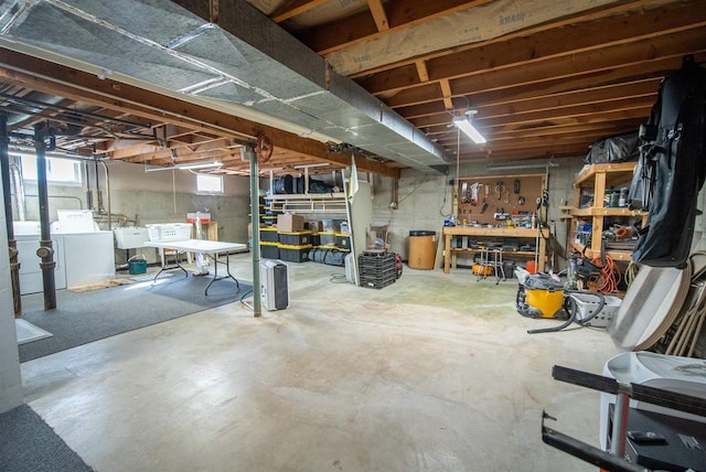 below grade area featuring washer and clothes dryer and a workshop area