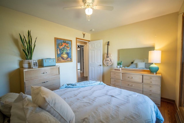 bedroom with ceiling fan, baseboards, and wood finished floors