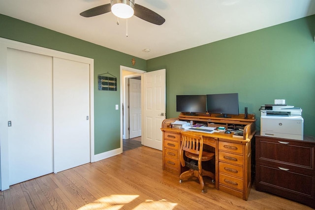 home office featuring baseboards, light wood-style floors, and a ceiling fan