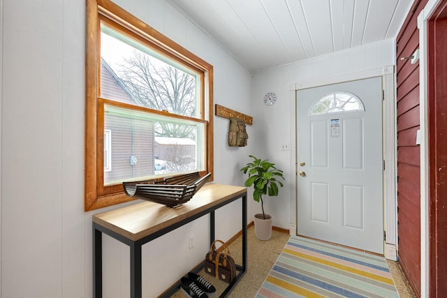 foyer entrance featuring light carpet