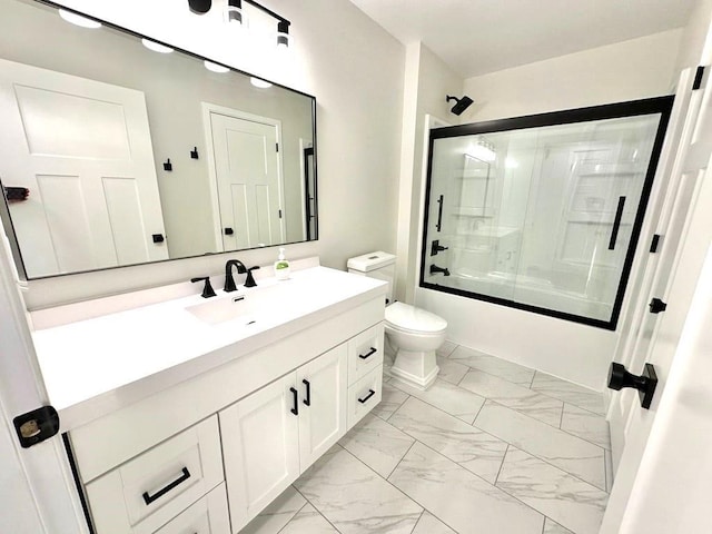 full bath featuring toilet, marble finish floor, shower / bath combination with glass door, and vanity