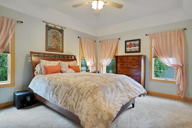 bedroom featuring baseboards, carpet, and multiple windows