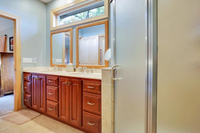 bathroom with a sink, double vanity, and a shower stall