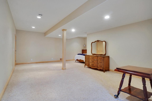 finished below grade area featuring baseboards, recessed lighting, and light carpet