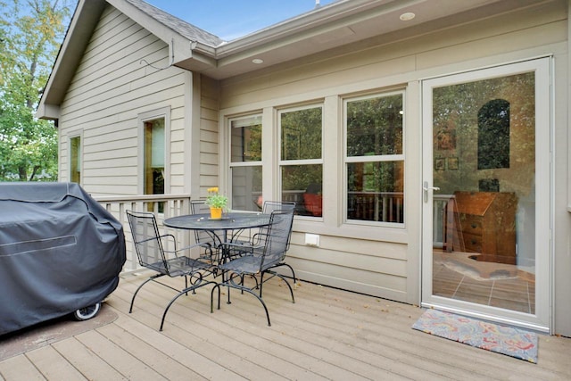 deck featuring a grill and outdoor dining space