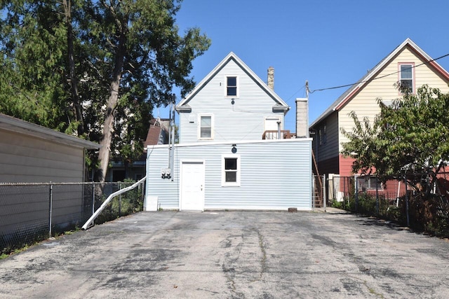 rear view of property with fence