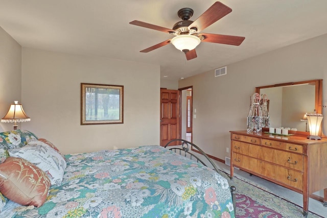 bedroom featuring baseboards, ceiling fan, visible vents, and light carpet