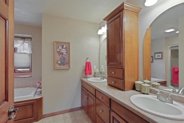 bathroom with double vanity, baseboards, a bath, and a sink