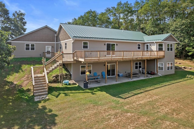 back of house with metal roof, a patio, a wooden deck, and stairs