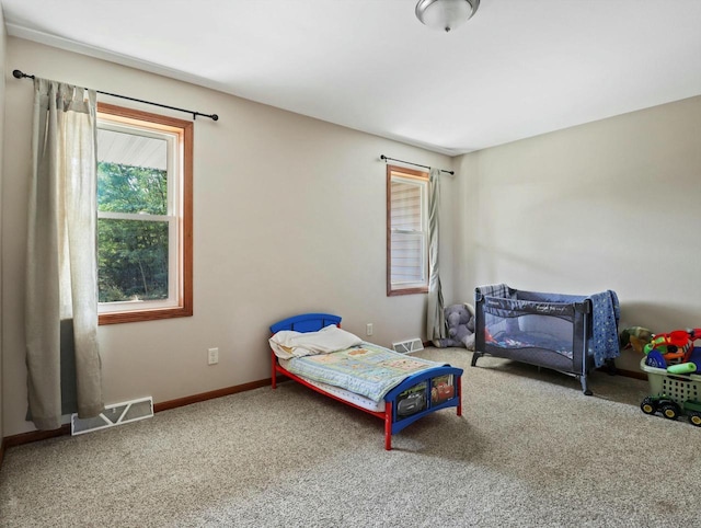 bedroom featuring carpet, visible vents, and baseboards