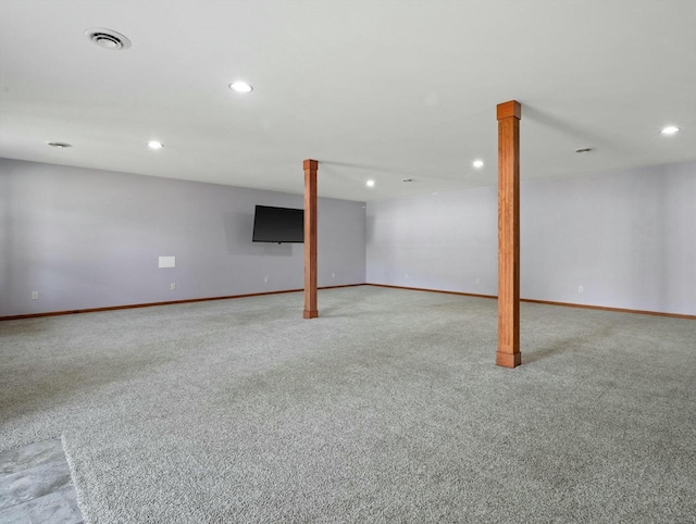 finished below grade area featuring recessed lighting, visible vents, light carpet, and baseboards