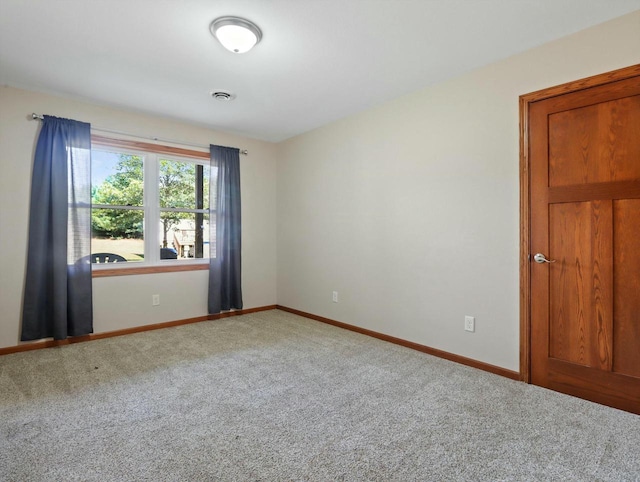 unfurnished room featuring carpet floors, baseboards, and visible vents