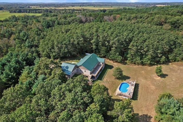 bird's eye view with a wooded view