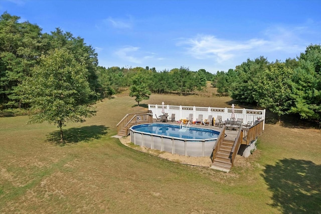 pool with a deck, a yard, and stairs