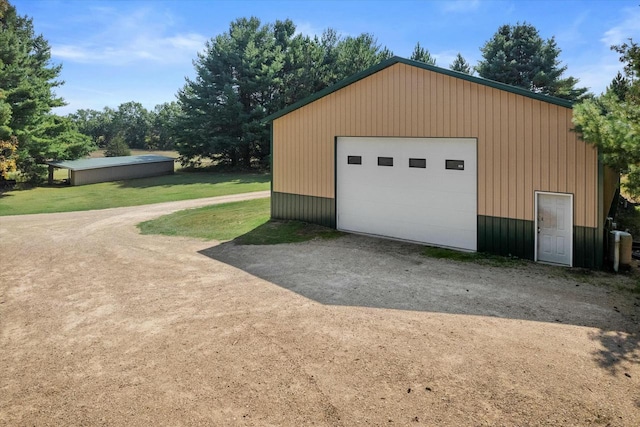 detached garage featuring dirt driveway