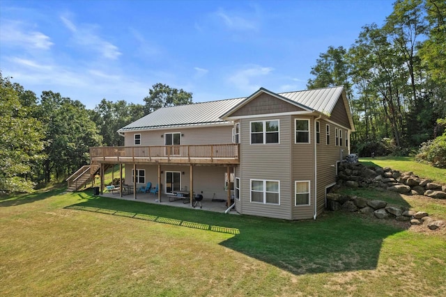 back of house featuring a patio area, a lawn, a wooden deck, and stairs