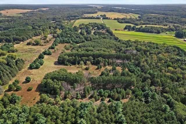 bird's eye view featuring a wooded view