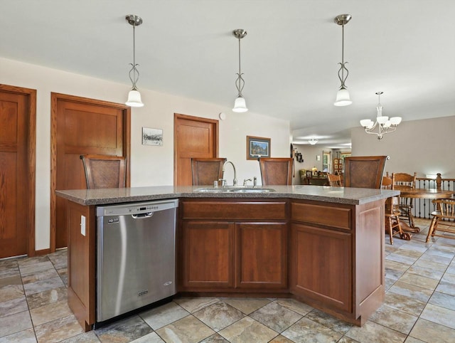 kitchen featuring a sink, dishwasher, decorative light fixtures, and an island with sink