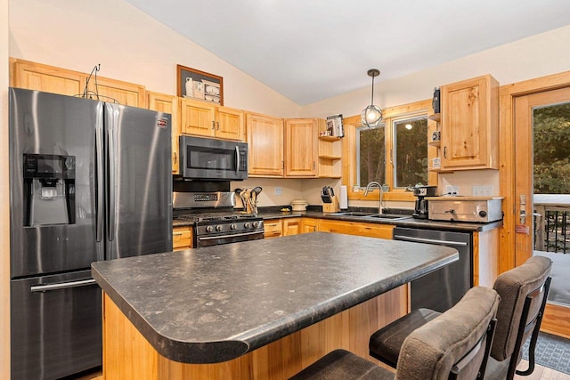 kitchen with dark countertops, appliances with stainless steel finishes, a center island, open shelves, and a sink