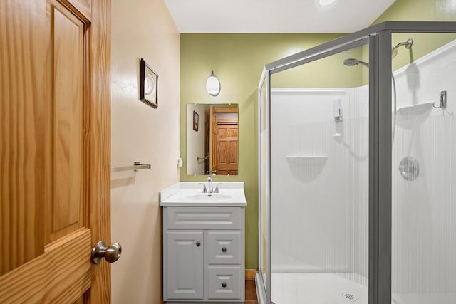 bathroom with a stall shower and vanity