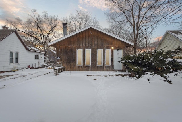 snow covered property featuring a chimney