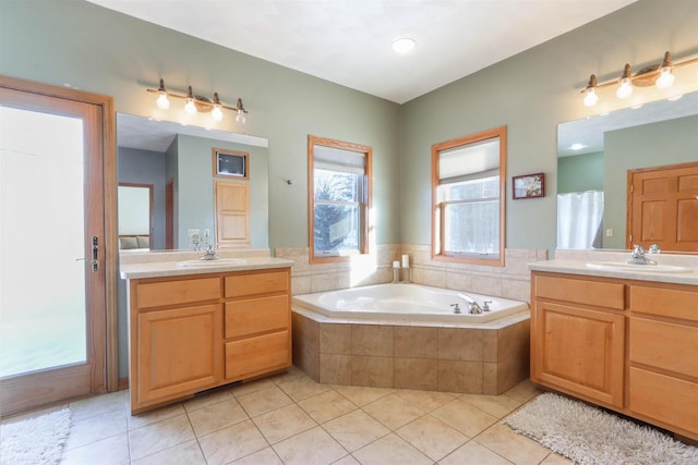 full bath featuring two vanities, a sink, and tile patterned floors