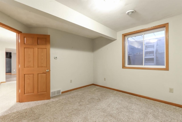 interior space with light carpet, baseboards, and visible vents