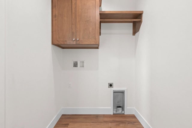 washroom with hookup for a washing machine, light wood-style flooring, baseboards, and electric dryer hookup