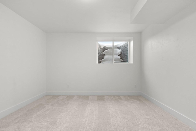 carpeted spare room with baseboards