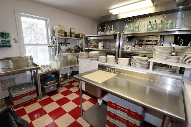 kitchen with stainless steel countertops and tile patterned floors